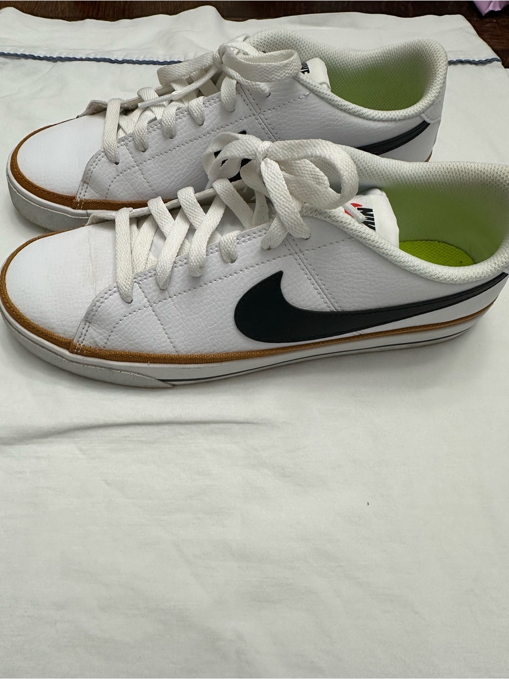 Nike women’s White Low-Top Sneakers with Black Swoosh